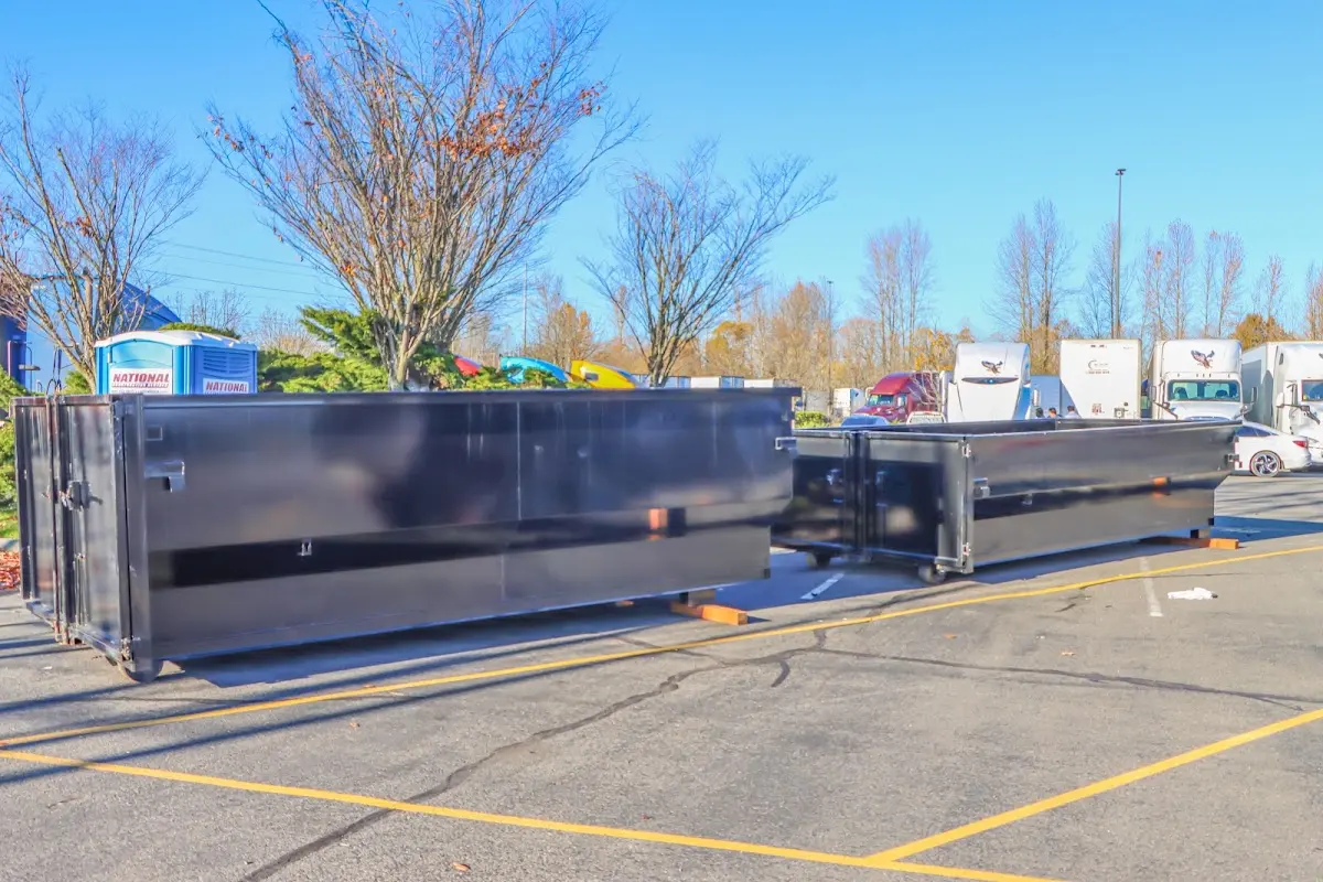 Professional dumpster rental service with roll-off container on residential driveway in Key Largo